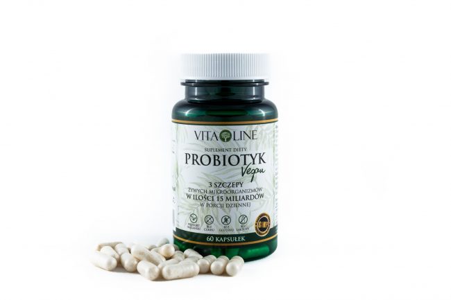 Kapsułki Probiotyk Vita-Line rozsypane obok pojemnika probiotyki vita-line Suplementy diety vita-line